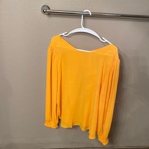 Long sleeve top, flowing, the v neck is the back side. Never worn tags are off.